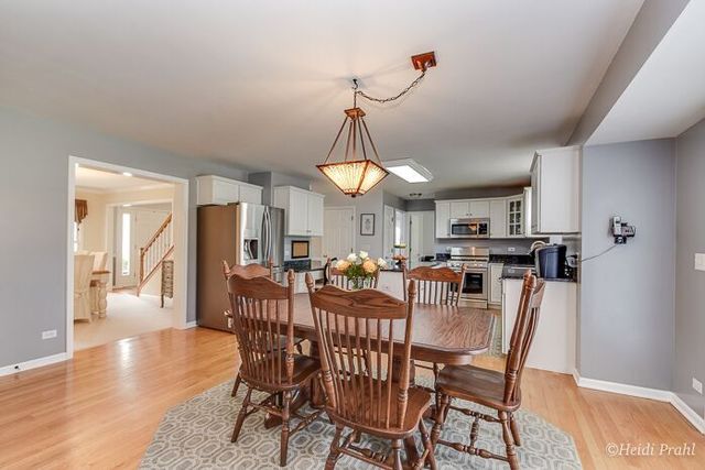 2107 Wicklow Road Naperville, IL 60564 - Photo 8 of 27 a view of a dining room with furniture window and wooden floor