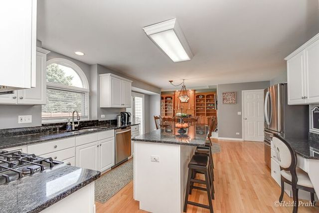 2107 Wicklow Road Naperville, IL 60564 - Photo 9 of 27 a kitchen with stainless steel appliances granite countertop a stove refrigerator sink and cabinets