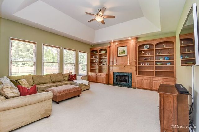 2107 Wicklow Road Naperville, IL 60564 - Photo 10 of 27 a living room with furniture a fireplace and a large window