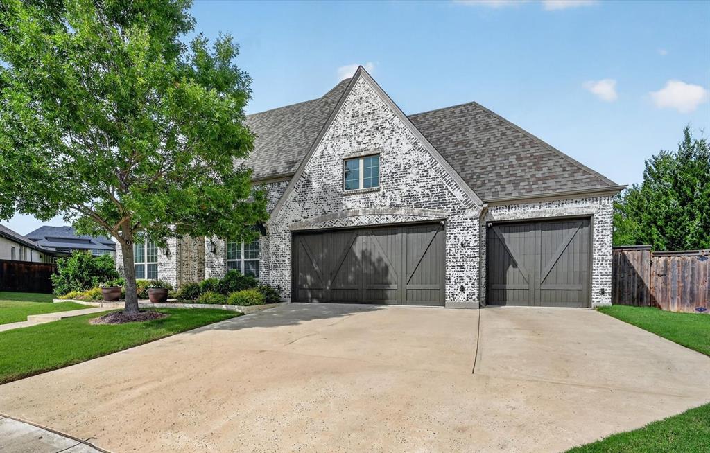 6656 Roughleaf Ridge Road Flower Mound, TX 76226 - Photo 37 of 40 a front view of a house with a garden and trees
