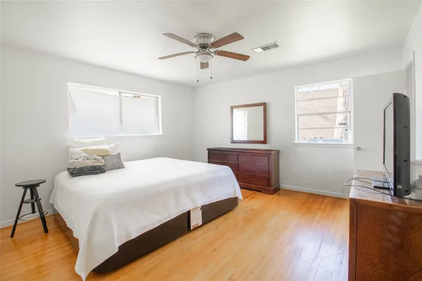a bedroom with a bed and a flat screen tv
