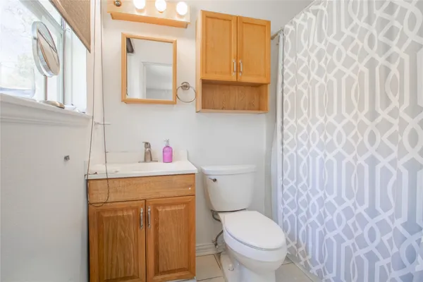 a white toilet sitting next to a bathroom sink