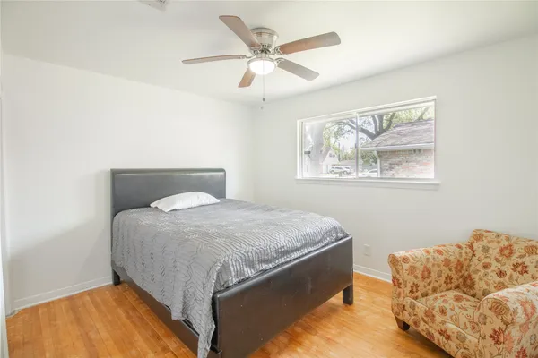 a bed sitting in a bedroom next to a window