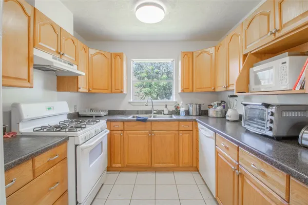 a kitchen with stainless steel appliances granite countertop a sink stove and cabinets