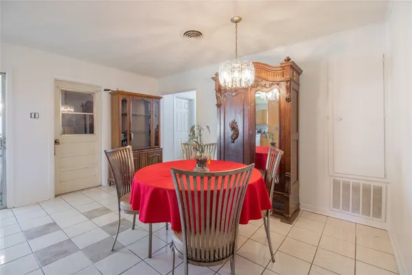a view of a dining room with furniture wooden floor and chandelier
