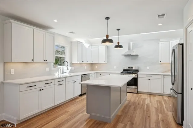 a kitchen with a sink stainless steel appliances and cabinets