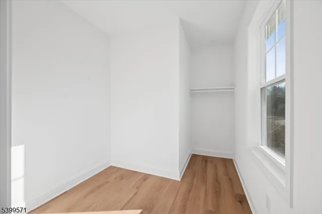 a view of wooden floor in a white cabinet