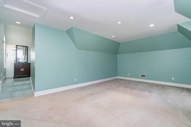 a view of an empty room with a fireplace and a chandelier