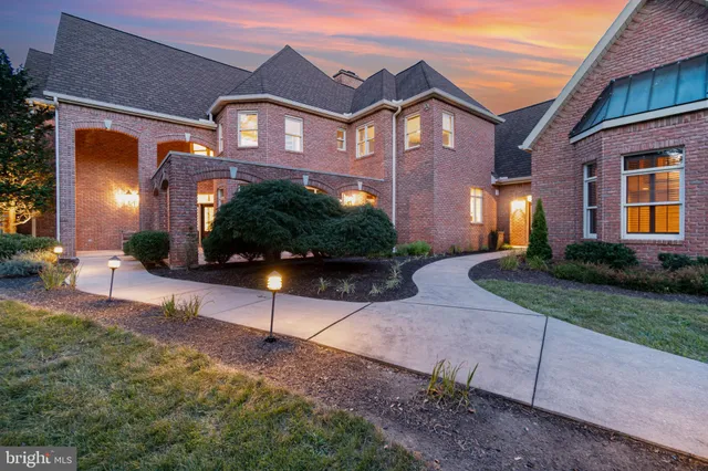 a front view of a house with a yard and outdoor seating