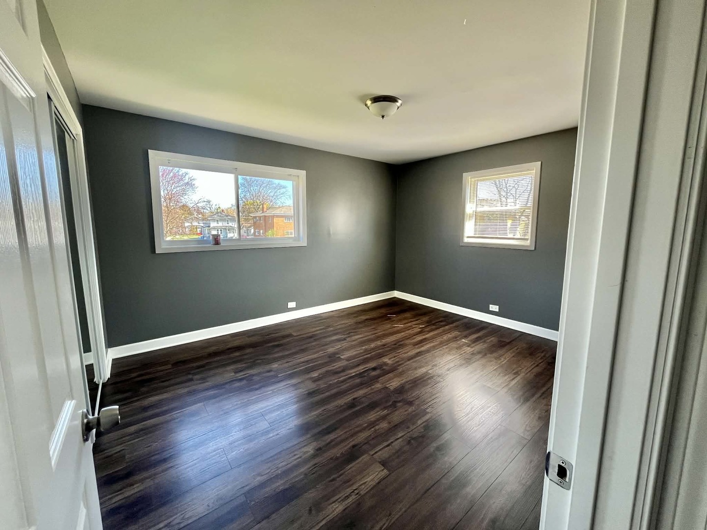 746 Walnut Street, Unit 2E Waukegan, IL 60085 - Photo 9 of 10 an empty room with wooden floor and windows