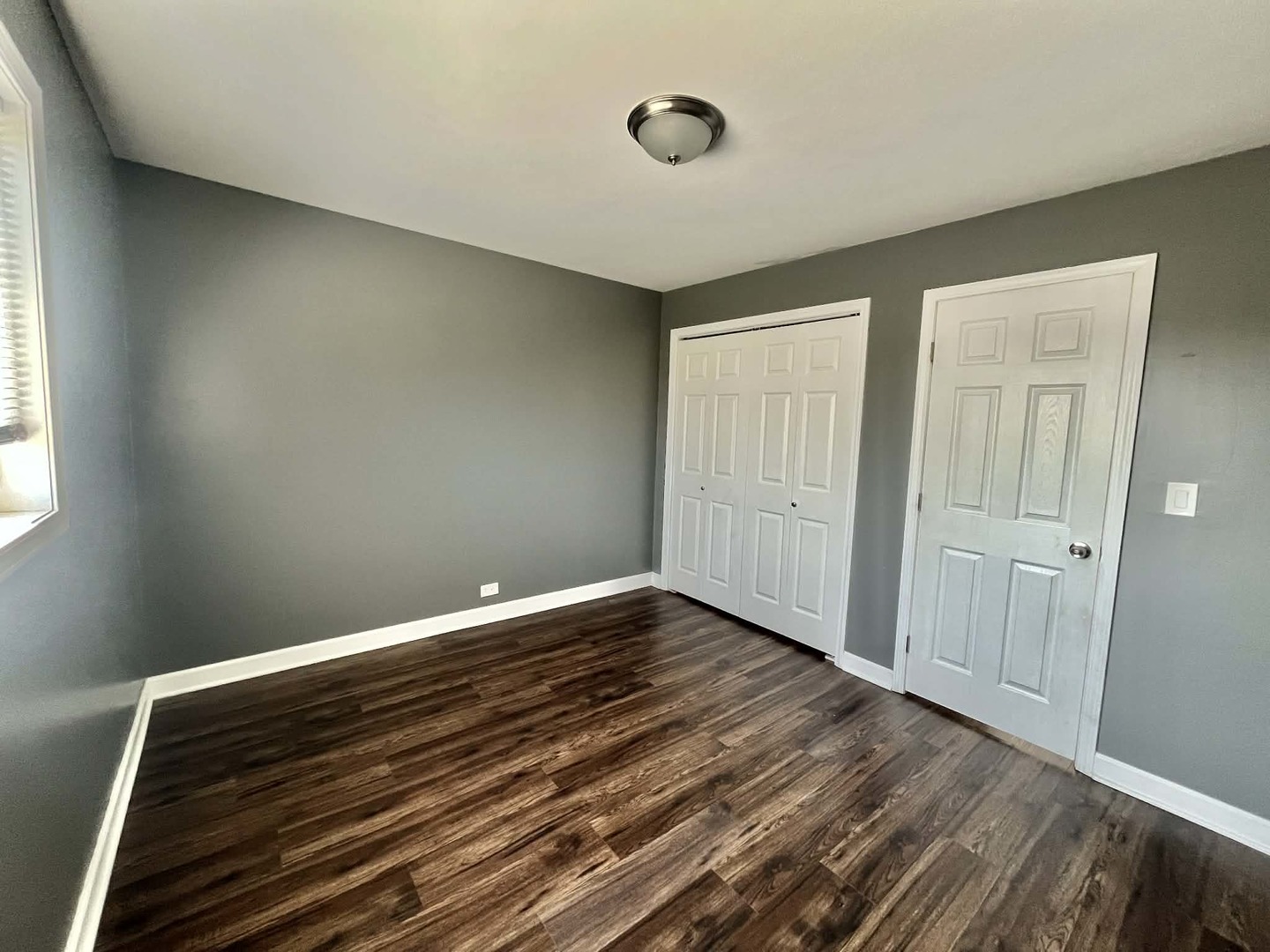 746 Walnut Street, Unit 2E Waukegan, IL 60085 - Photo 10 of 10 a view of wooden floor and windows in a room