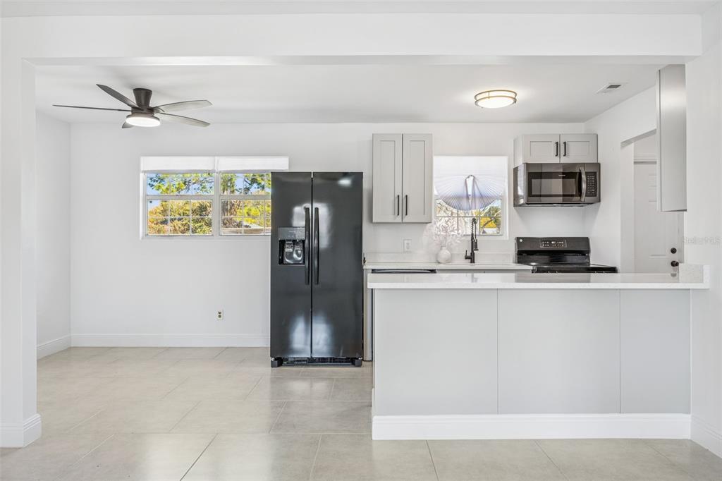 314 Wurst Road Ocoee, FL 34761 - Photo 13 of 35 a kitchen with stainless steel appliances a refrigerator a sink a stove and white cabinets