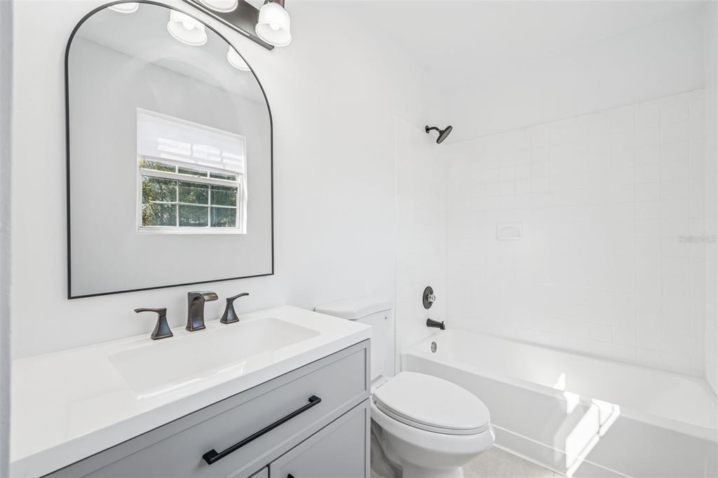314 Wurst Road Ocoee, FL 34761 - Photo 29 of 35 a bathroom with a sink a toilet and a mirror