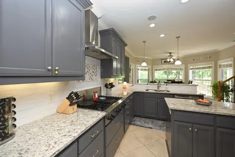 a kitchen with granite countertop cabinets and oven