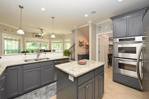 a kitchen with a stove a refrigerator and a sink