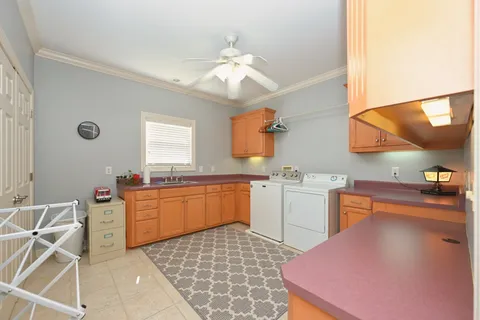 a kitchen with a sink a stove and cabinets