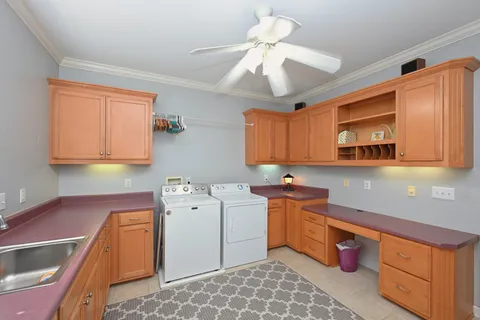 a bathroom with a granite countertop sink mirror and a toilet