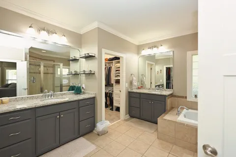 a bathroom with a double vanity sink and a mirror