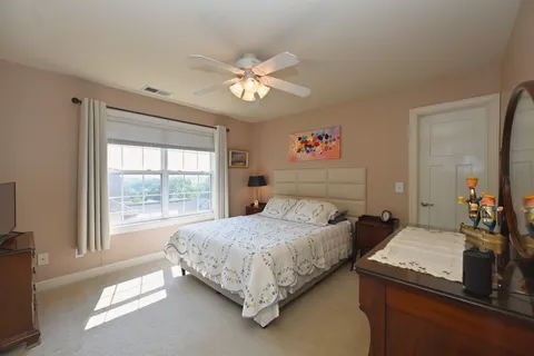 a bedroom with a bed furniture and a window