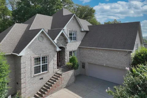 a view of a house with sitting area and garden