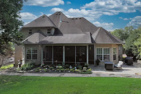 a grassy field with trees in the background