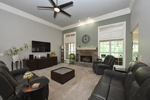 a living room with furniture a flat screen tv and a fireplace