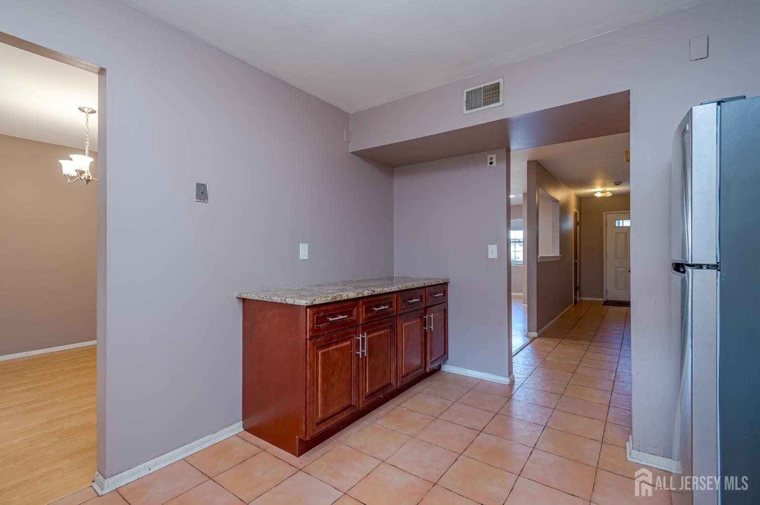5601 Hana Road Edison, NJ 08817 - Photo 11 of 27 a view of a hallway with wooden floor