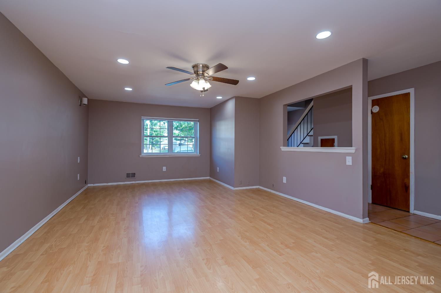 5601 Hana Road Edison, NJ 08817 - Photo 14 of 27 wooden floor in an empty room with a window