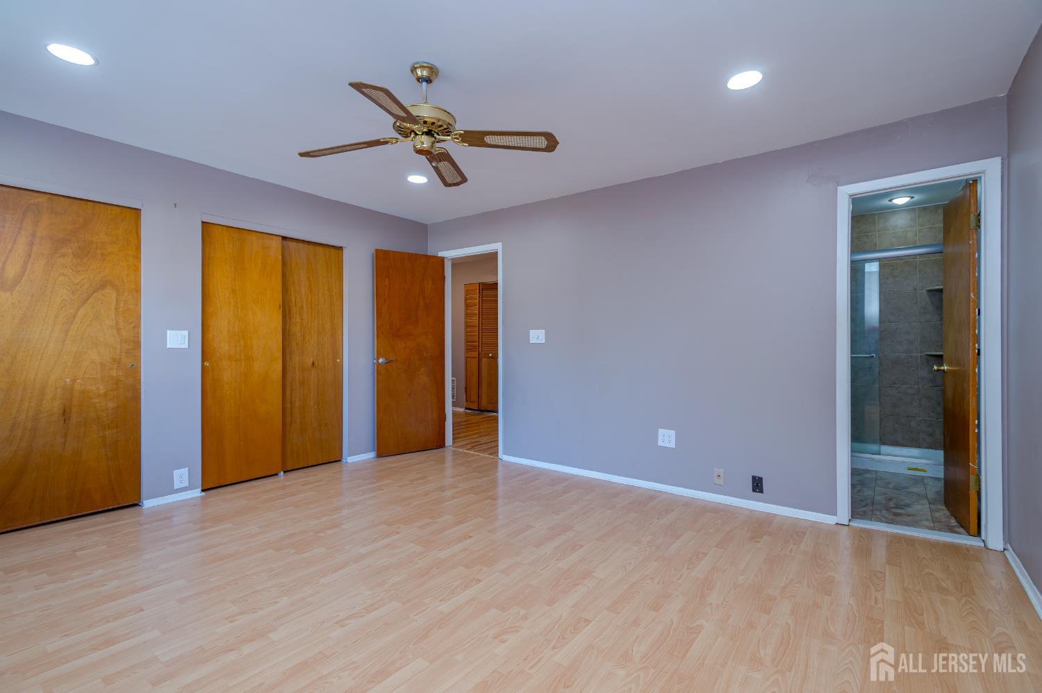 5601 Hana Road Edison, NJ 08817 - Photo 17 of 27 a view of an empty room with window and wooden floor
