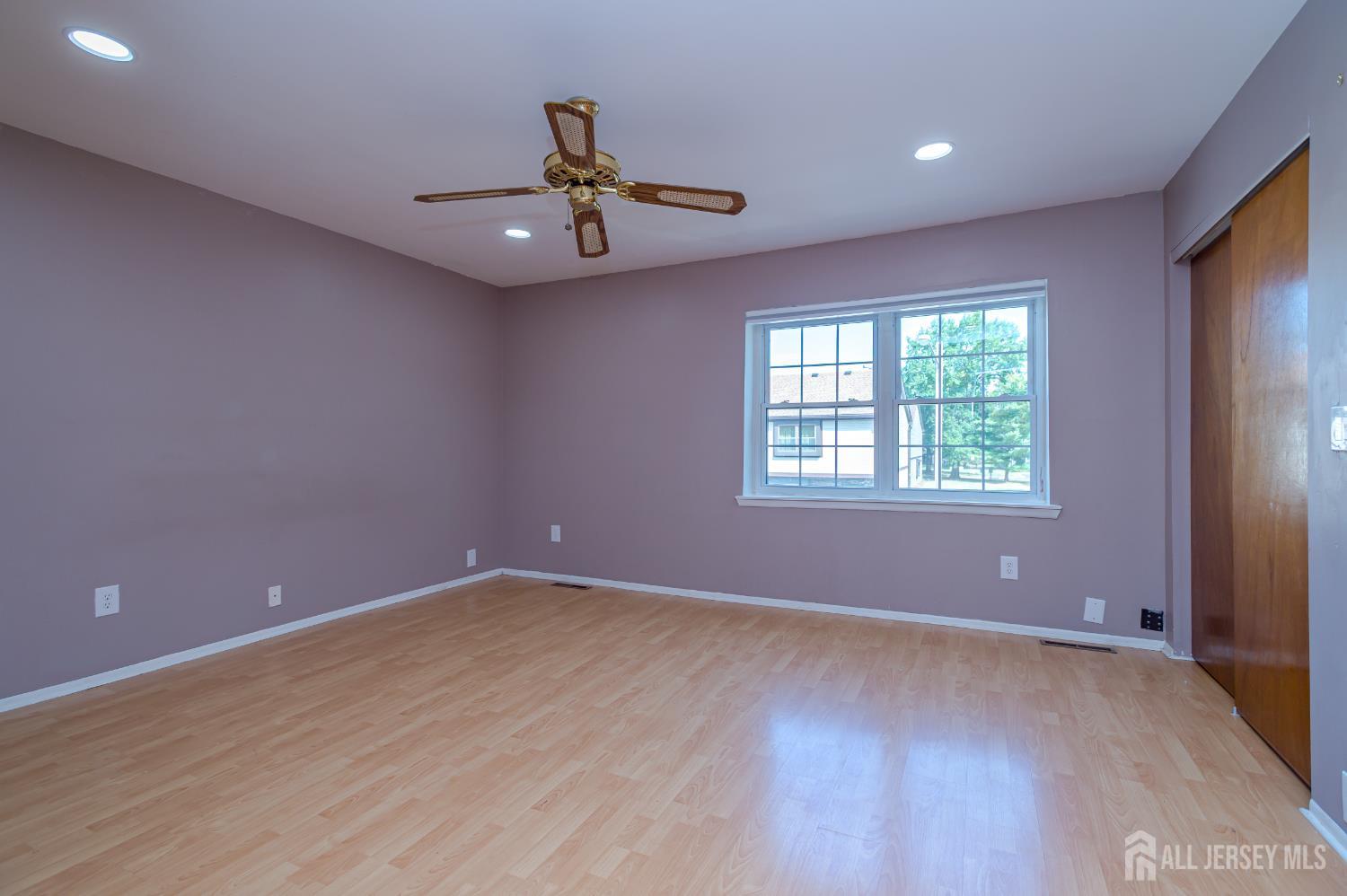 5601 Hana Road Edison, NJ 08817 - Photo 18 of 27 an empty room with a window and ceiling fan