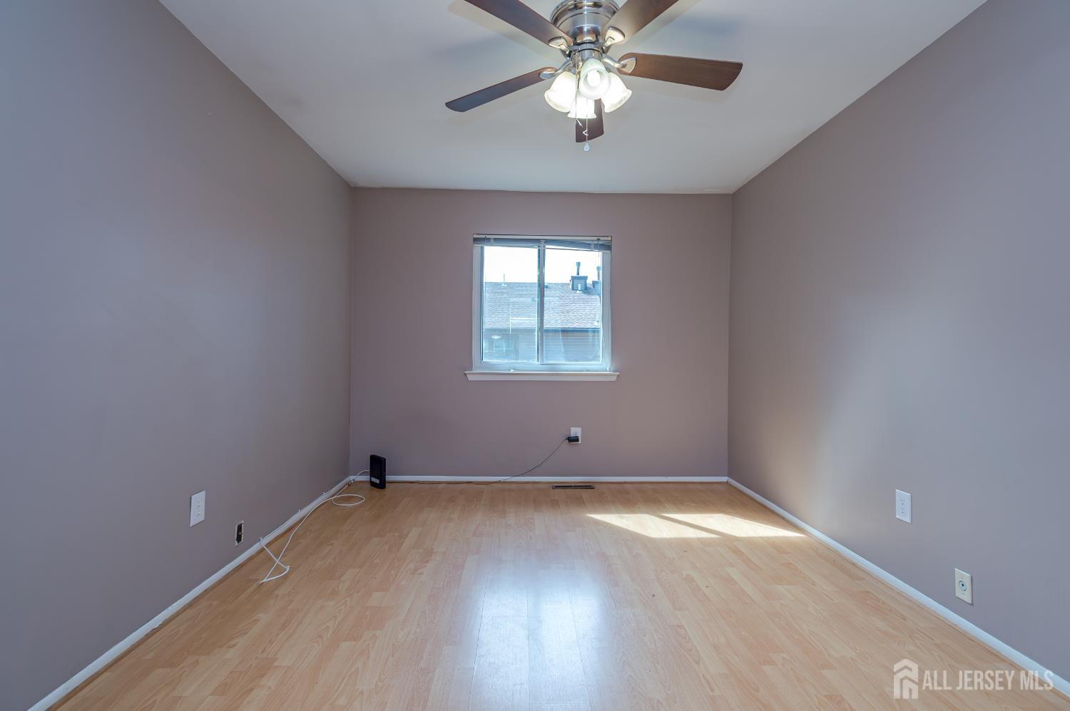 5601 Hana Road Edison, NJ 08817 - Photo 20 of 27 an empty room with a window and a fan