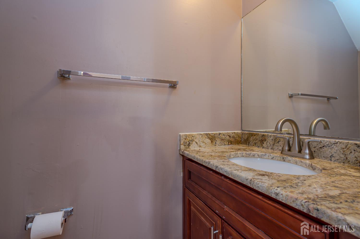 5601 Hana Road Edison, NJ 08817 - Photo 5 of 27 a bathroom with a granite countertop sink and mirror