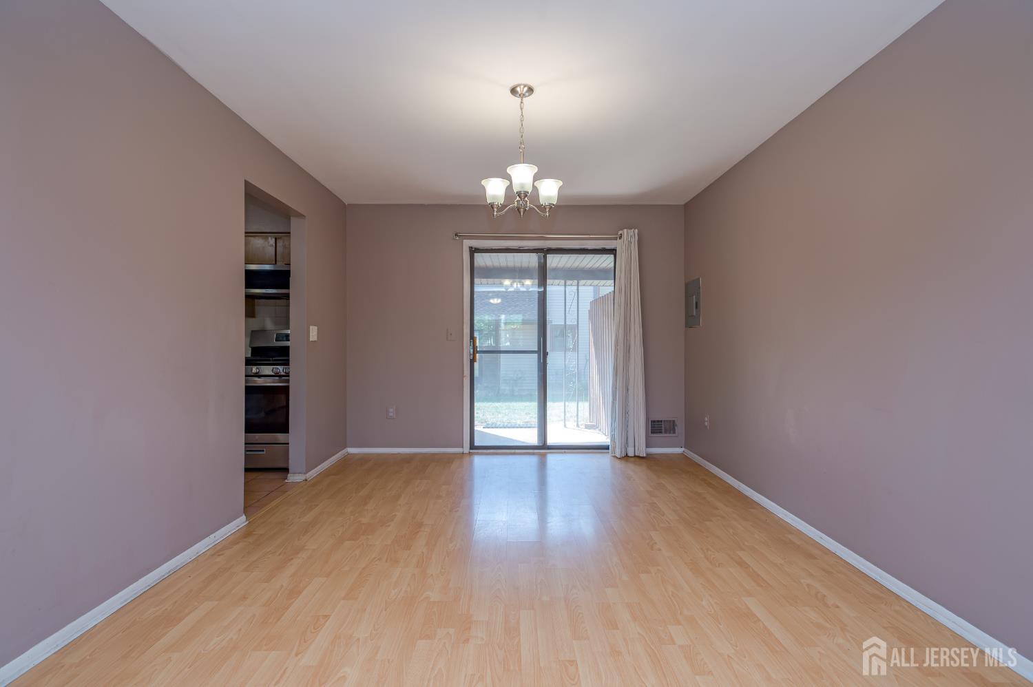 5601 Hana Road Edison, NJ 08817 - Photo 9 of 27 wooden floor in an empty room with a window