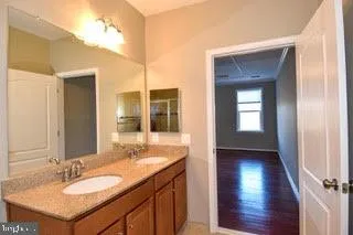 a bathroom with a sink double vanity and a mirror