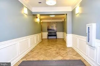 a view of a hallway with wooden floor and furniture