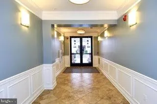 a view of a hallway with wooden floor and windows