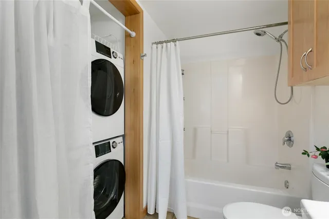 a bathroom with a shower a toilet and sink