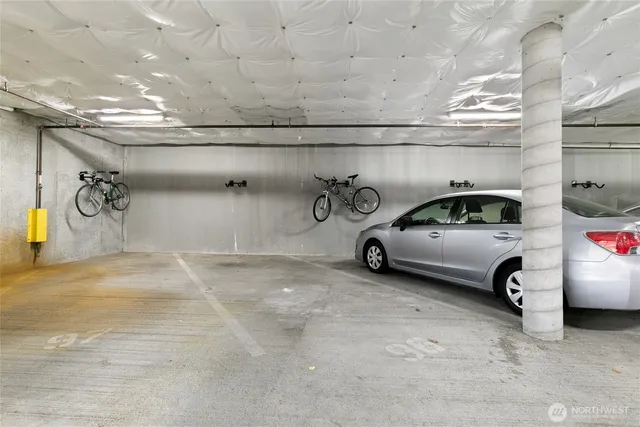 a view of parking garage with cars parked