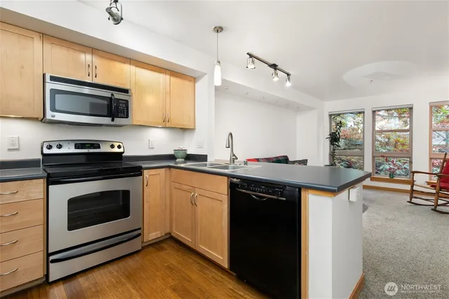 a kitchen with a sink stove and microwave
