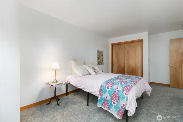 a bedroom with a bed and a lamp