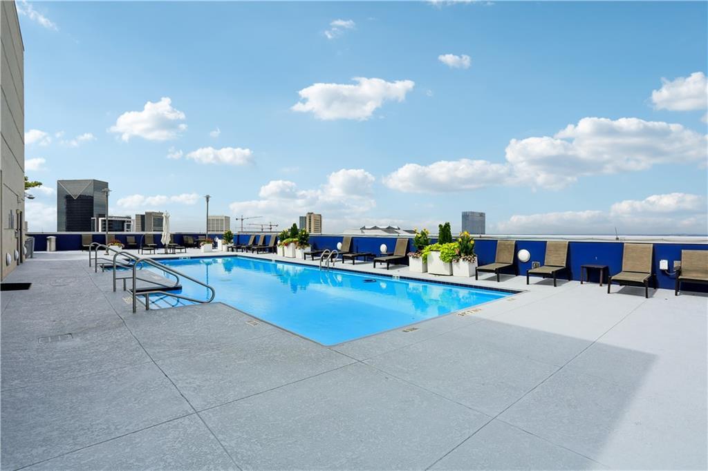 285 Centennial Olympic Park Drive Northwest, Unit 1209 Atlanta, GA 30313 - Photo 12 of 17 a swimming pool with outdoor seating