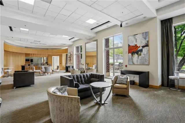 a living room with fireplace furniture and a large window