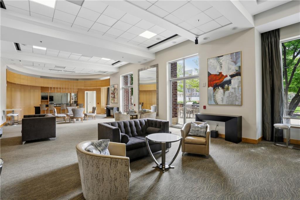 285 Centennial Olympic Park Drive Northwest, Unit 1209 Atlanta, GA 30313 - Photo 13 of 17 a living room with fireplace furniture and a large window