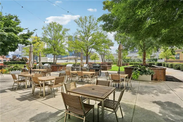 a view of a patio with table and chairs and potted plants