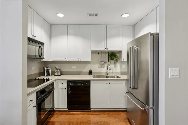 a kitchen with stainless steel appliances granite countertop a refrigerator sink and cabinets