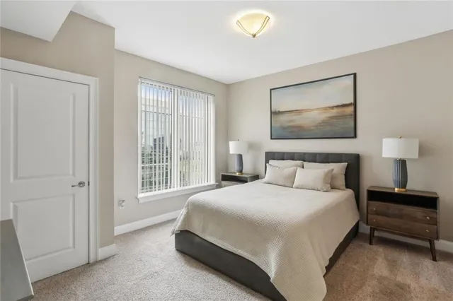 a bedroom with a bed and a lamp