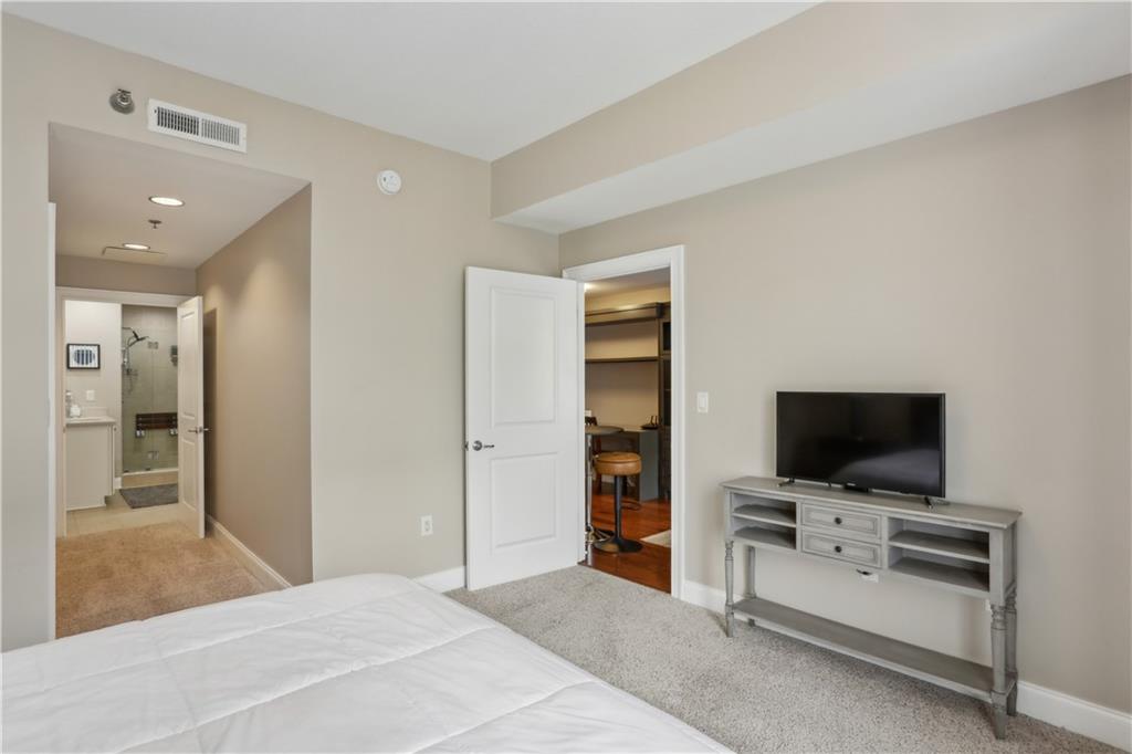 285 Centennial Olympic Park Drive Northwest, Unit 1209 Atlanta, GA 30313 - Photo 6 of 17 a view of a livingroom with furniture and flat screen tv