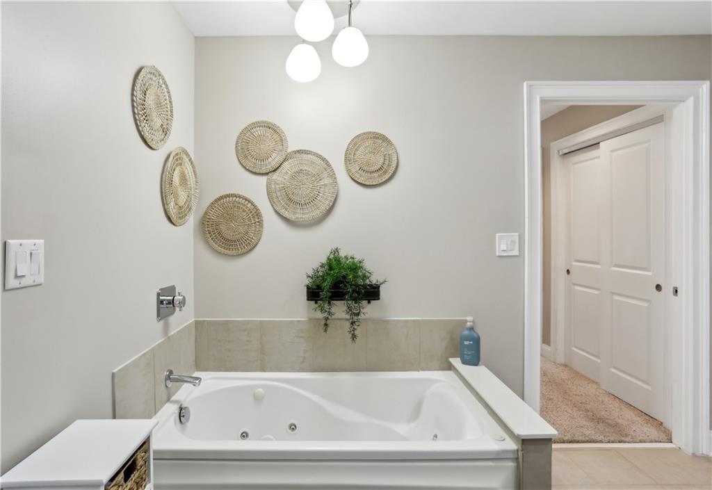 285 Centennial Olympic Park Drive Northwest, Unit 1209 Atlanta, GA 30313 - Photo 8 of 17 a bathroom with a sink and a mirror