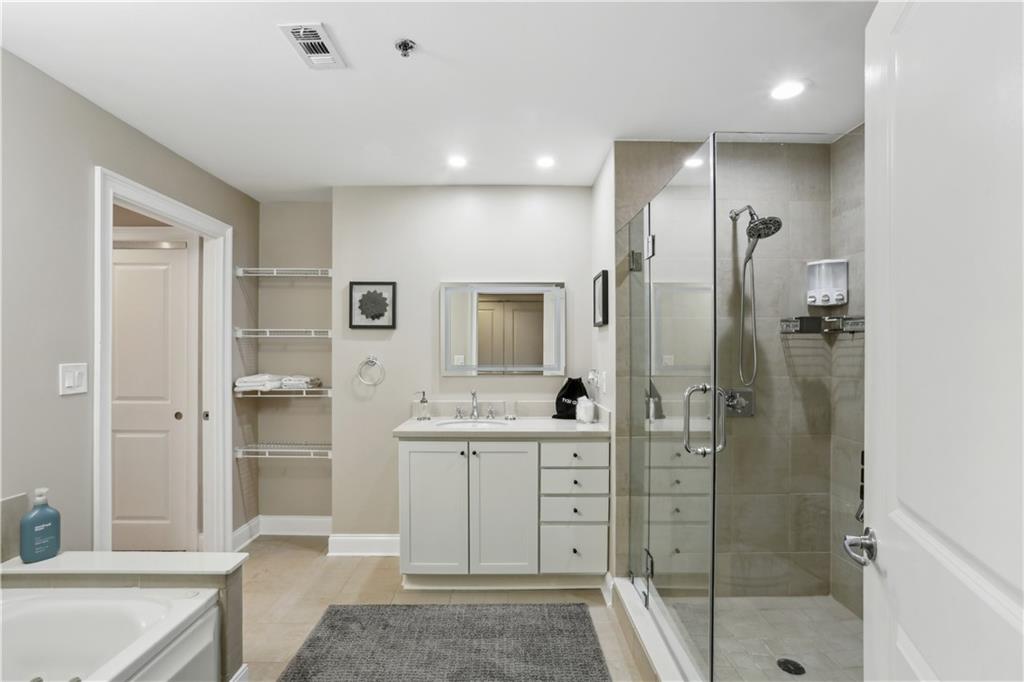 285 Centennial Olympic Park Drive Northwest, Unit 1209 Atlanta, GA 30313 - Photo 9 of 17 a bathroom with a sink a toilet and shower