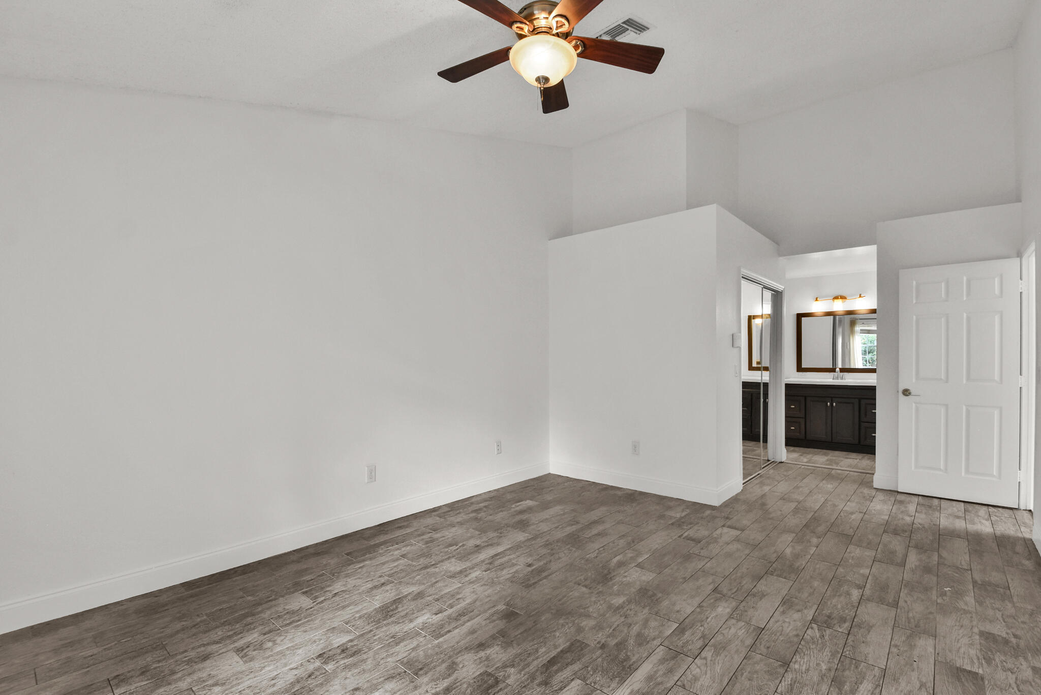 13175 Quiet Woods Road, Unit A Wellington, FL 33414 - Photo 13 of 46 an empty room with a empty space and a ceiling fan